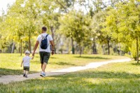 Father and son walking along path